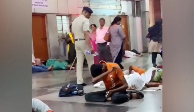 Viral Video: रेलवे स्टेशन पर सो रहे यात्रियों को उठाने के लिए पुलिसकर्मी ने बोतल से डाला पानी, वीडियो हुई वायरल