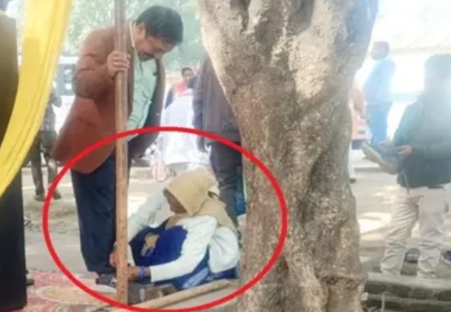 SDM tying shoe laces of a woman in MP