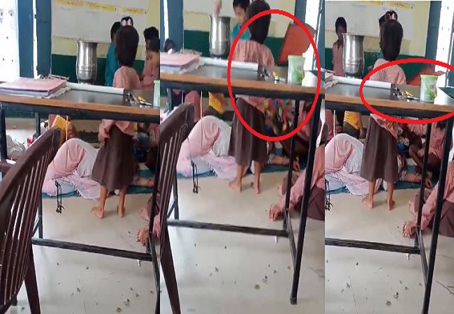 Primary school girls fanning sleeping teacher