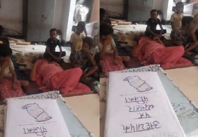 a teacher is seen lying among the children.