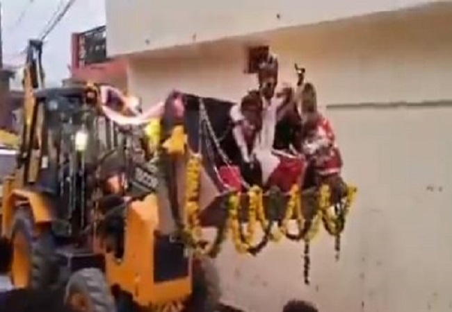 groom rides on a bulldozer to pick up brides