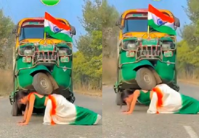 A girl wearing a tricolor saree lifted the auto on her back and started doing pushups.