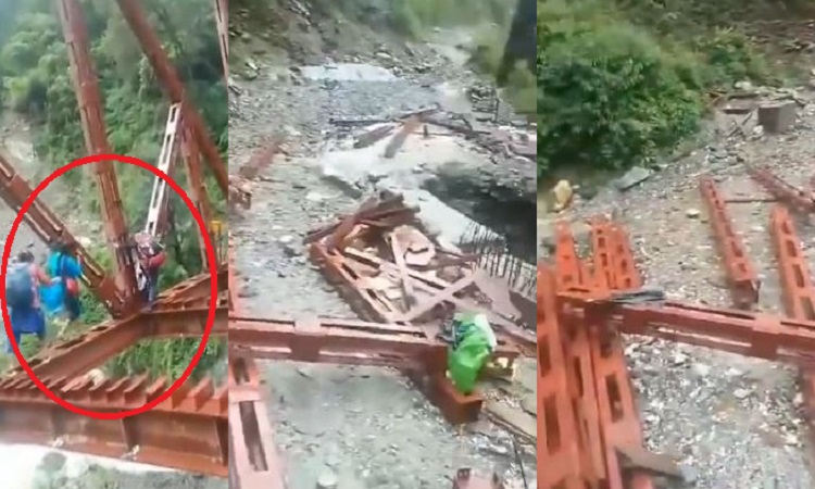 People crossing the bridge under construction, risking their lives