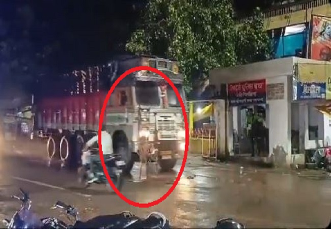 a person sat on a chair in the middle of a moving road