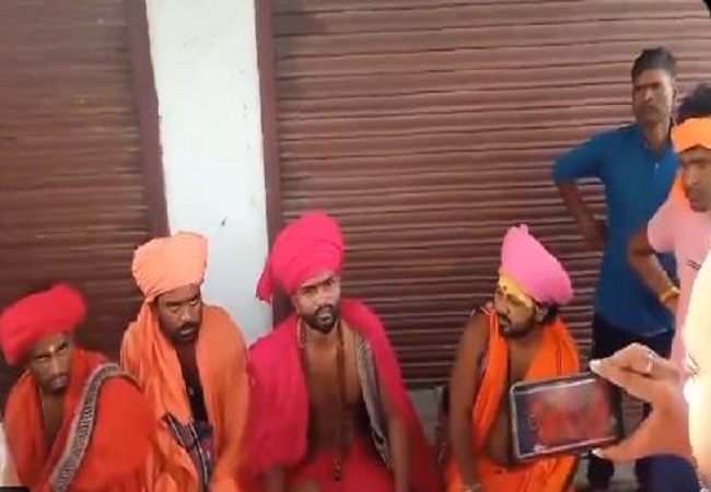 four fake sadhus were taken hostage and beaten.