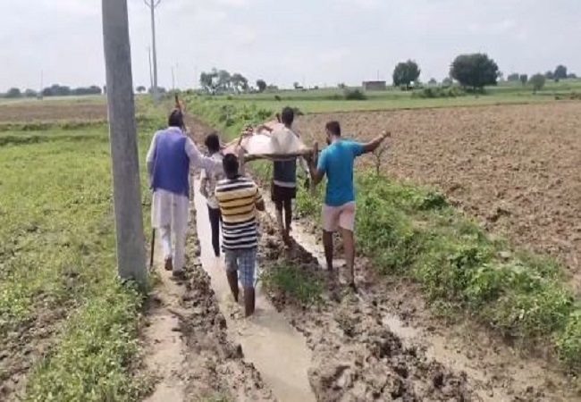 patient was carried to the hospital on a cot in the mud