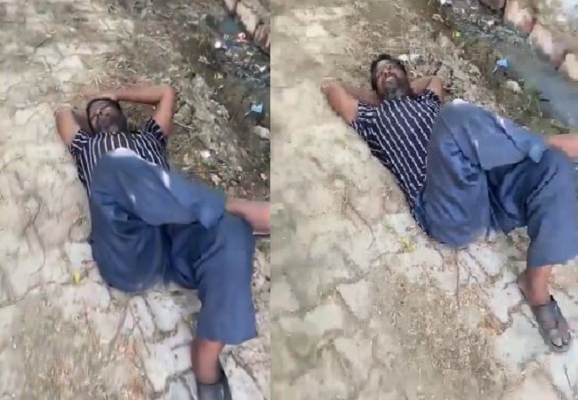 Drunken government teacher lying on the bank of the drain